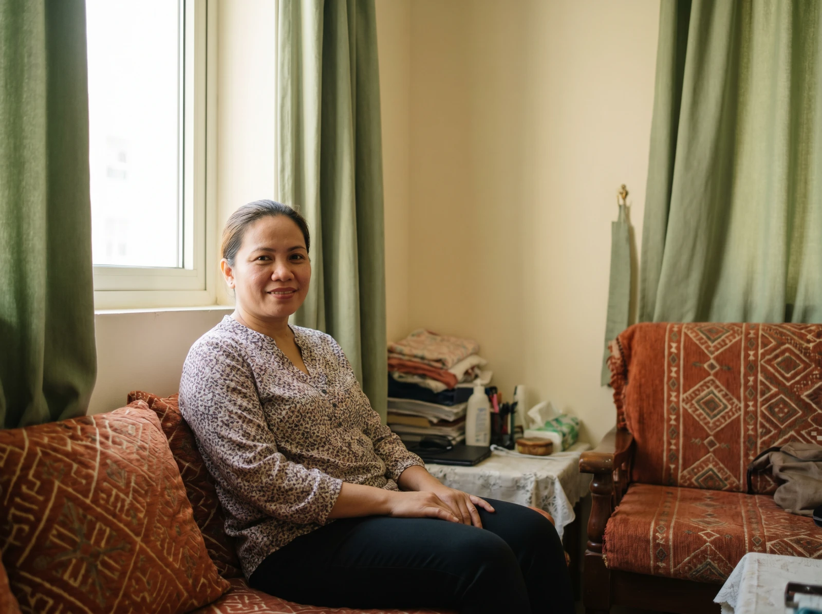 A caregiver smiling in warm daylight